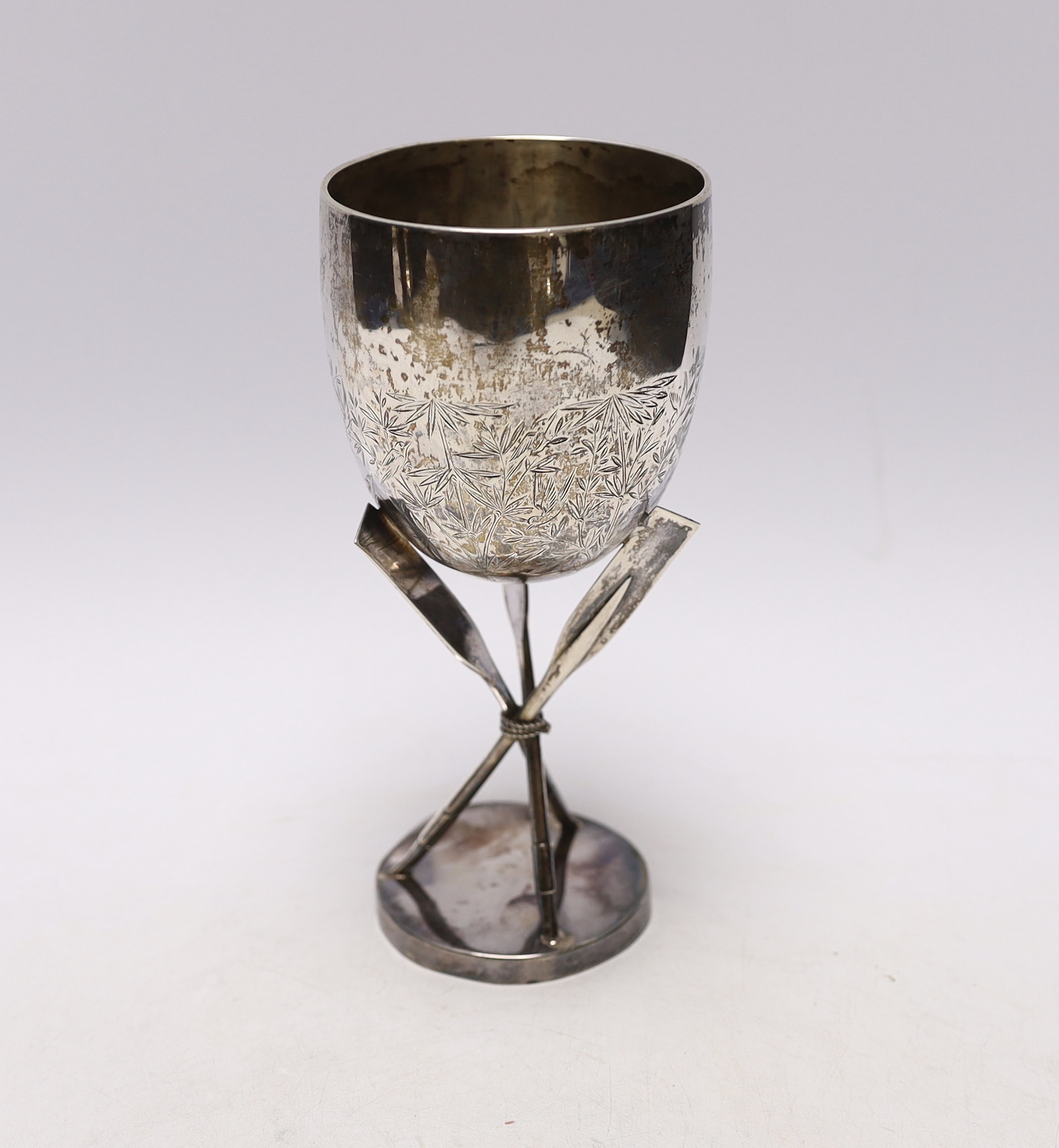 A late 19th century Chinese sterling presentation 'Hong Kong Regatta' rowing trophy goblet, with crossed oar supports and engraved inscription dated 1887, 18.4cm, 7.5oz.